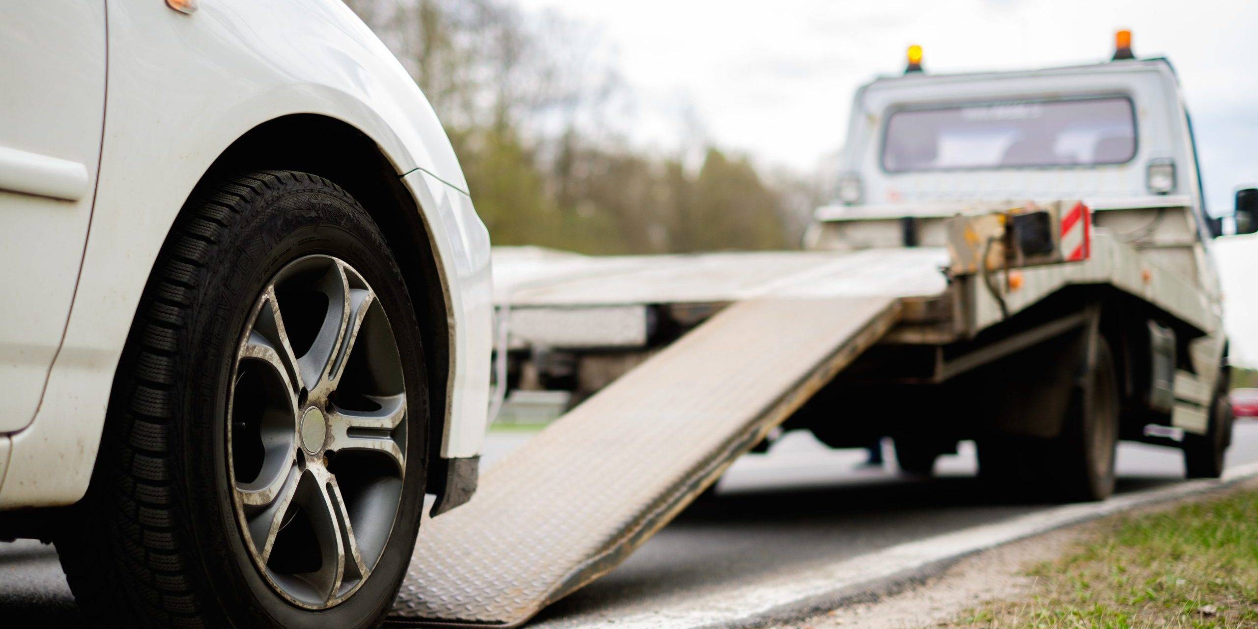 Loading Broken Car On A Tow Truck On A Roadside Loading Broken Car On A Tow Truck On A Roadside